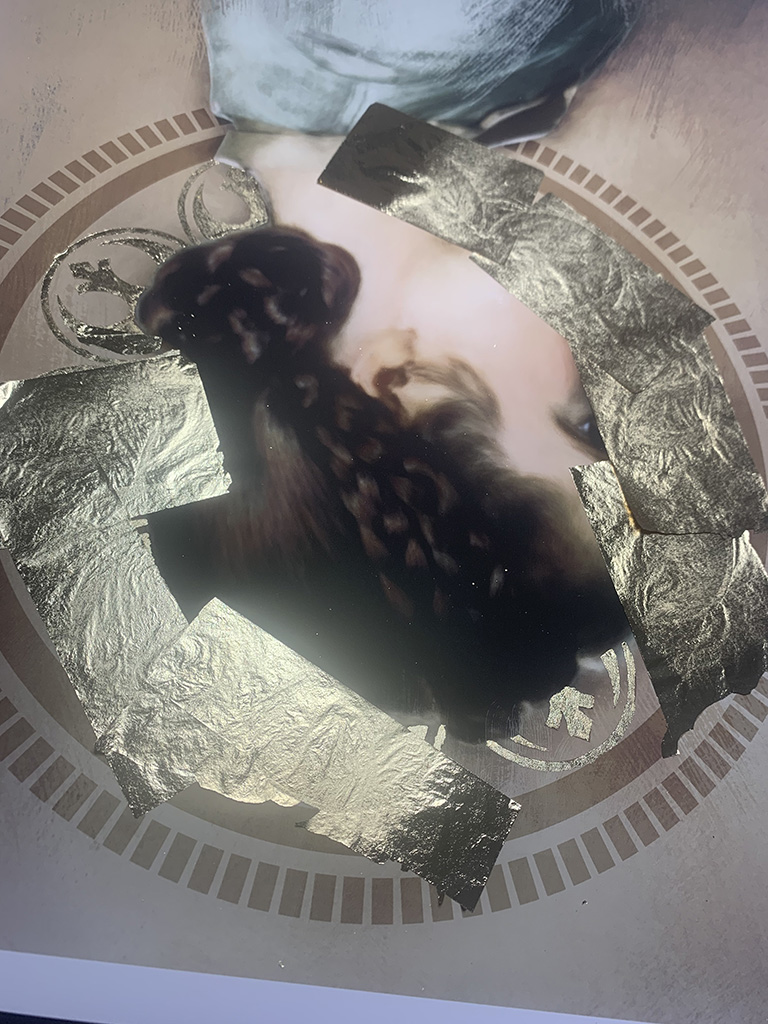 Laying down gold-leaf on portrait