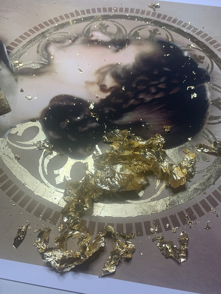 Aftermath of brushing up loose gold leaf on portrait.